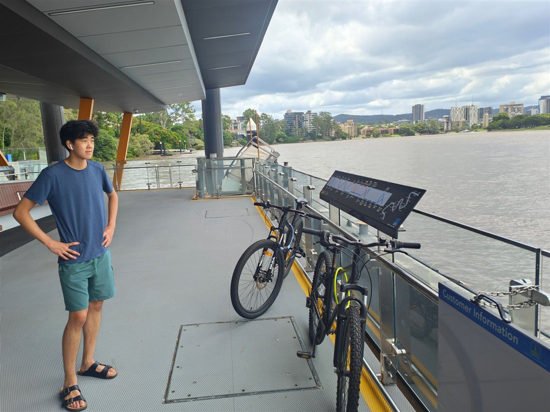 Leo waiting at a Brisbane River ferry terminal with two bikes loaded on board