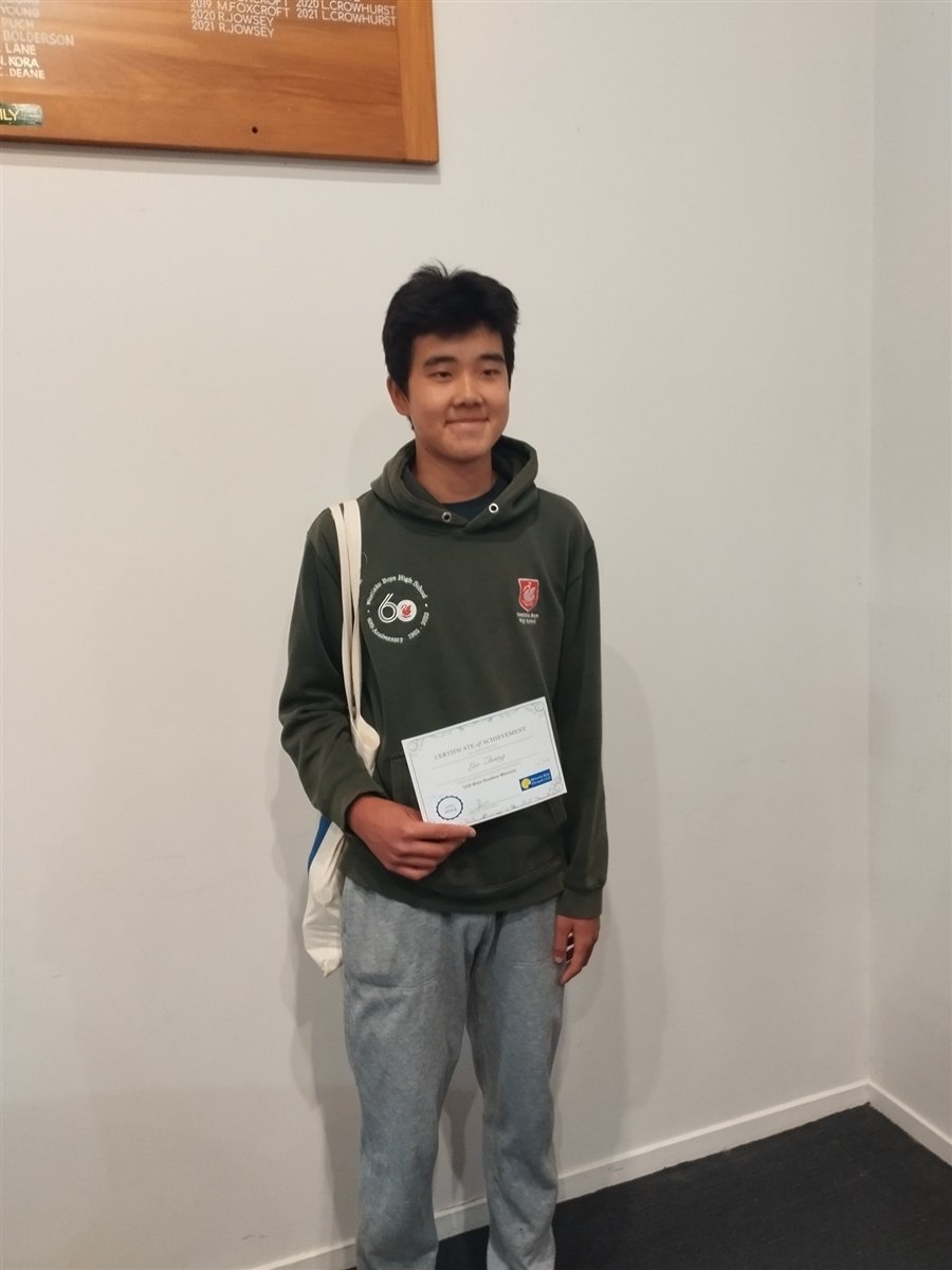 Leo Zheng holding his U16 Boys Doubles Winners certificate from Browns Bay Racquets Club