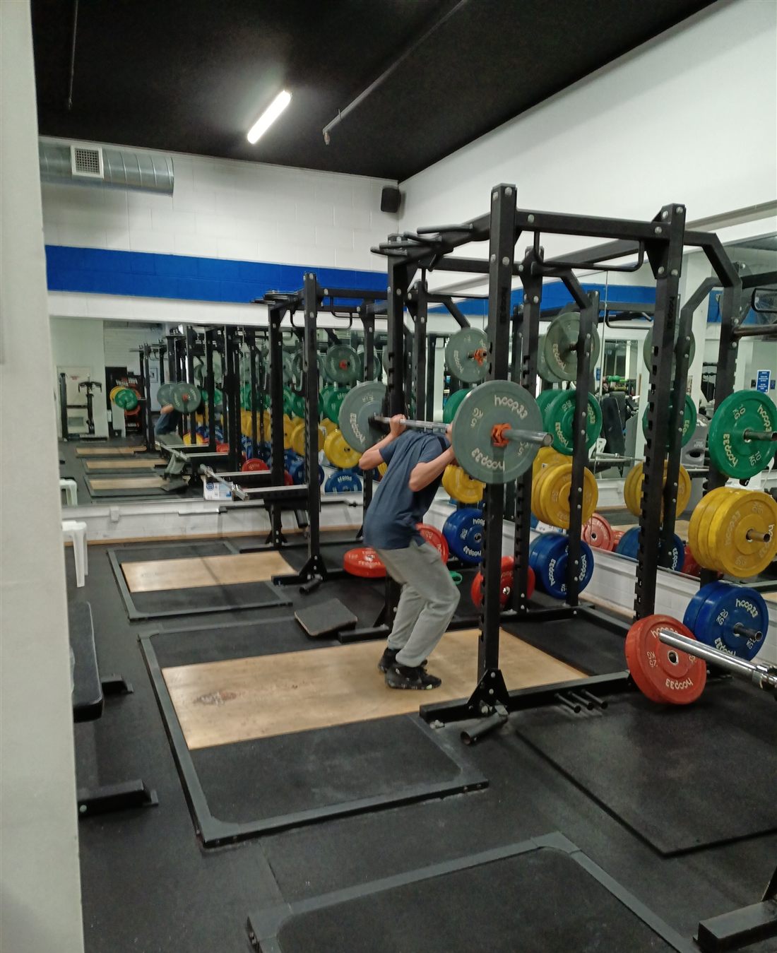 Strength training with a barbell in a gym
